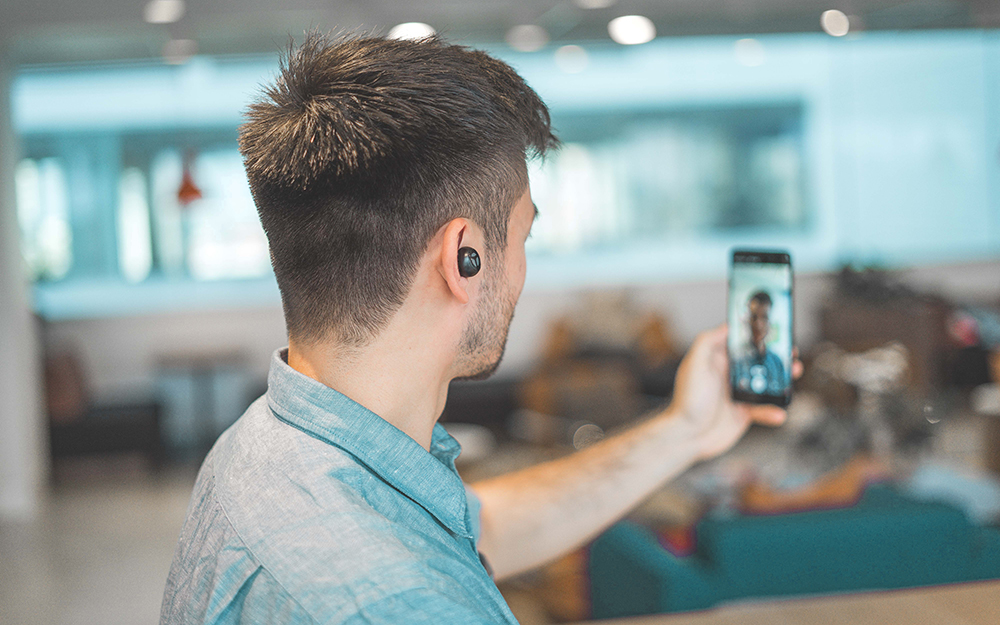 A person capturing a selfie, sharing a moment and connecting with others through social media.