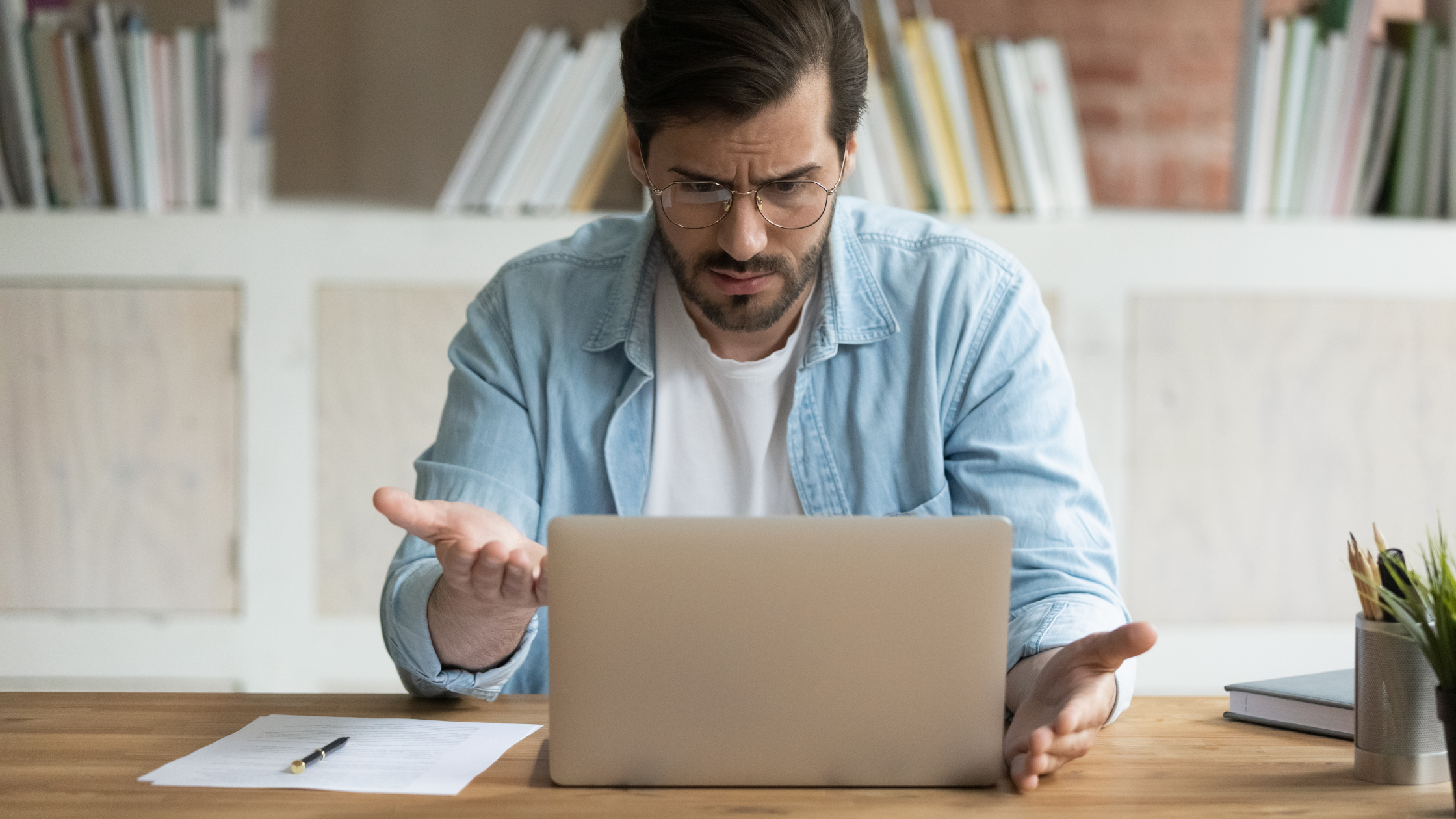 A problematic man working on his laptop navigating Common website mistakes that can hinder your online success and how to avoid them.