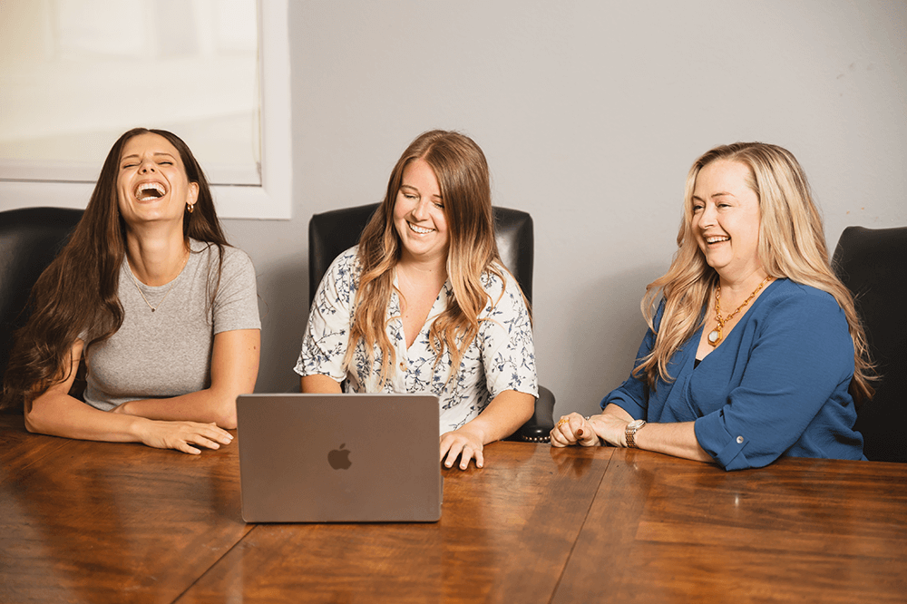 Candid group photo of the Life in Motion Marketing team laughing with each other