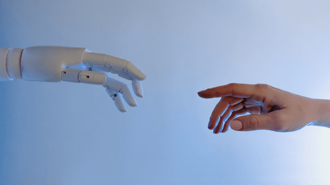 Robotic hand reaching out to human hand symbolizing AI revolution in digital marketing