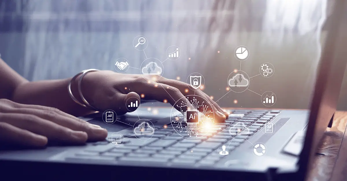 A person's hands typing on a laptop, with a glowing AI chip graphic overlaid and surrounded by cloud and data icons.