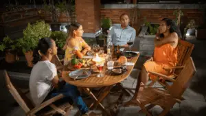 A group of friends sharing a meal and conversation, representing the goal of brand storytelling to become a topic of real-world social media branding and discussion.